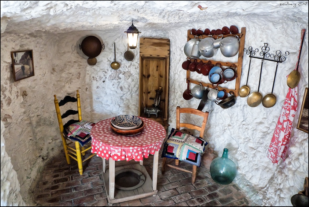 Sacromonte caves in Granada lit at dusk, what to do in Granada, with a flamenco tablao atmosphere.